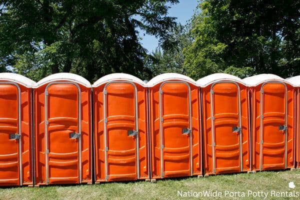 a lineup of clean and well-maintained portable loos for workers in Dillingham, AK